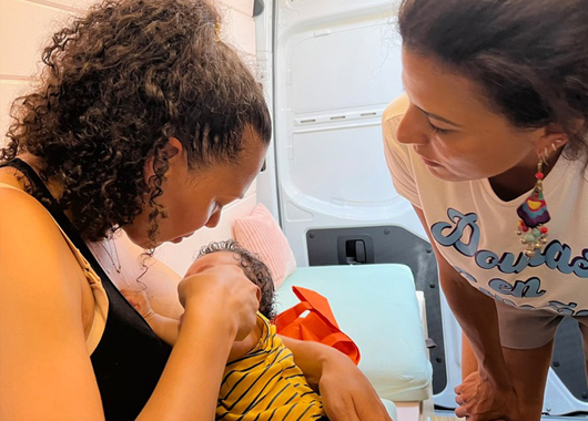 Woman advising a new mother about breastfeeding